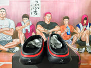 Rear view of the black clogs with red trim and small heel marks.