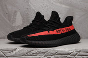 Pair of black SPLV-350 sneakers with red side stripes shown from a front three-quarter angle.