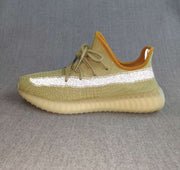 Side profile of a green Yeezy 350 V2-style sneaker with a bright reflective stripe and translucent ribbed outsole.