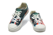 Front views of multicolor split-toe lace-up sneakers with dark green panels.