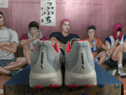 Rear view of white and gray Brooks Hyperion Max shoes with orange-red accents