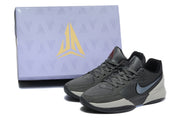 Gray Jordan sneakers placed in front of a Jordan-branded shoebox.
