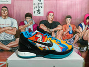 Side view of a Nike basketball sneaker showing the multicolor graphic upper, black Swoosh, black midsole section, and blue outsole.