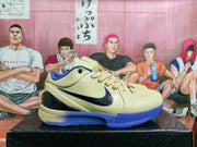 Side profile of a beige low-top basketball sneaker with a black Swoosh, blue outsole, and textured toe and heel details.