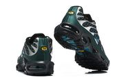 Rear and outsole views of green and black Nike Air Max Plus sneakers.