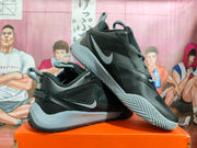 Angled view showing the sides and patterned outsole of black and grey Nike basketball shoes
