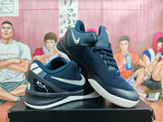 Angled view of navy Nike basketball sneakers showing the side Swoosh, textured upper, heel graphics, and white outsole.