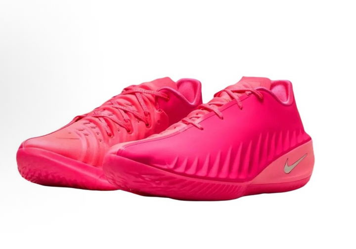 Pair of bright pink Nike basketball sneakers with lace-up fronts, textured side detailing, and metallic Swooshes.