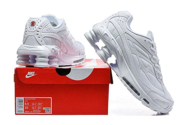 White Nike Shox Ride 2 sneakers displayed with a red shoe box; the box label shows a sample size.