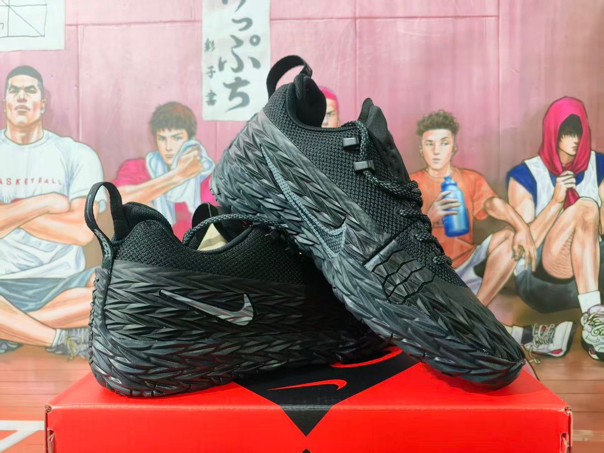Pair of black and gray Nike sneakers displayed on a red shoebox, showing the textured side panels and Nike Swoosh.
