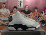 Side profile showing the dimpled white-grey panel and navy section of a Jordan basketball shoe.