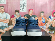 Front view of navy Nike basketball sneakers showing the laces, dark toe panels, tongue logos, and white outsoles.