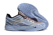 Blue-gray camouflage Nike Ja 2 shoe beside a patterned outsole