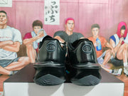 Rear view of black basketball shoes showing GT heel branding