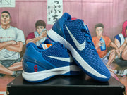 Side view of blue Nike Kobe shoes showing white Swoosh details and a red number 8 on the heel.