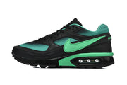 Side view of a black and mint-green Nike Air Max sneaker.