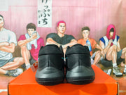 Rear view of black basketball shoes with dark gray heel panels.