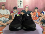 Front view of black Nike sneakers with textured forefoot panels, black laces, and contrasting gray midsoles.