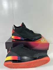Angled product view showing the black upper, elephant-print overlays, multicolor heel accent, and red outsole.