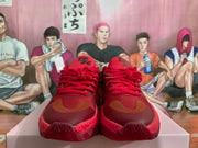 Front view showing the red laces, contrasting brown toe overlays and textured toe outsole.