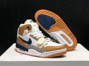 Jordan Legacy 312 sneakers displayed with one outsole facing upward, showing the gum and navy tread pattern.