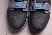 Close-up of the perforated toe boxes and grey forefoot straps with blue branding.
