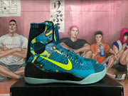 Side view of a blue high-top basketball shoe with a bright volt Swoosh, patterned panels, and pale aqua outsole.