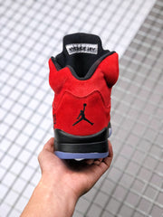 Rear view of the red sneaker showing the black Jumpman logo and translucent outsole edge.