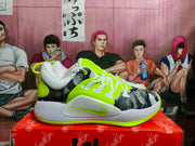 Side view of a Nike Zoom basketball sneaker with neon green upper panels, gray midsole, and black patterned overlays.