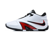 Side view of a white basketball shoe with black and red side details
