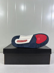 Bottom view showing the navy rubber outsole, red circular forefoot traction area and Jordan branding.