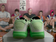 Rear view of light green and white Jordan basketball sneakers showing padded collars, heel panels, and green outsoles.