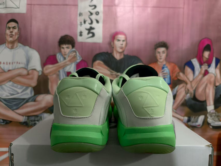 Rear view of light green and white Jordan basketball sneakers showing padded collars, heel panels, and green outsoles.