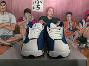 Front view showing white laces and navy panels on Jordan basketball sneakers