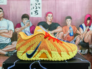 Side view of an orange and yellow Nike basketball shoe with red laces and a dark blue Swoosh.