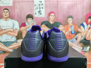 Rear view of black basketball sneakers with purple heel accents and visible heel logos.