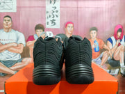 Rear view of a pair of black Nike basketball shoes showing the textured heel panels.