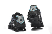 Rear view of the black and blue Nike Shox TL sneakers.