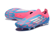 Pair of pink and blue laceless F50 soccer cleats, showing the patterned uppers and studs.