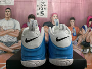 Rear view showing black Nike Swooshes, blue heel sections, white collars, and Foamposite tongue labels.