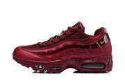 Side profile of a burgundy Nike Air Max 95 TT sneaker with mesh panels and visible sole cushioning