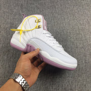Side view of one sneaker showing the light gray side panel and pink outsole.