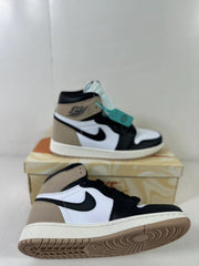 Angled view of the sneakers showing the side panels, high-top construction, padded collar, and outsole edge.