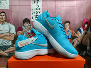 Pair of blue Nike basketball shoes shown at an angle