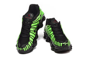 Front view of green-and-black Nike Shox TL sneakers.