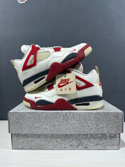 Pair of white and red high-top sneakers shown from opposite sides with a branded hangtag and shoe box.