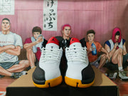 Front view of white, black, and yellow Jordan high-top sneakers with white laces
