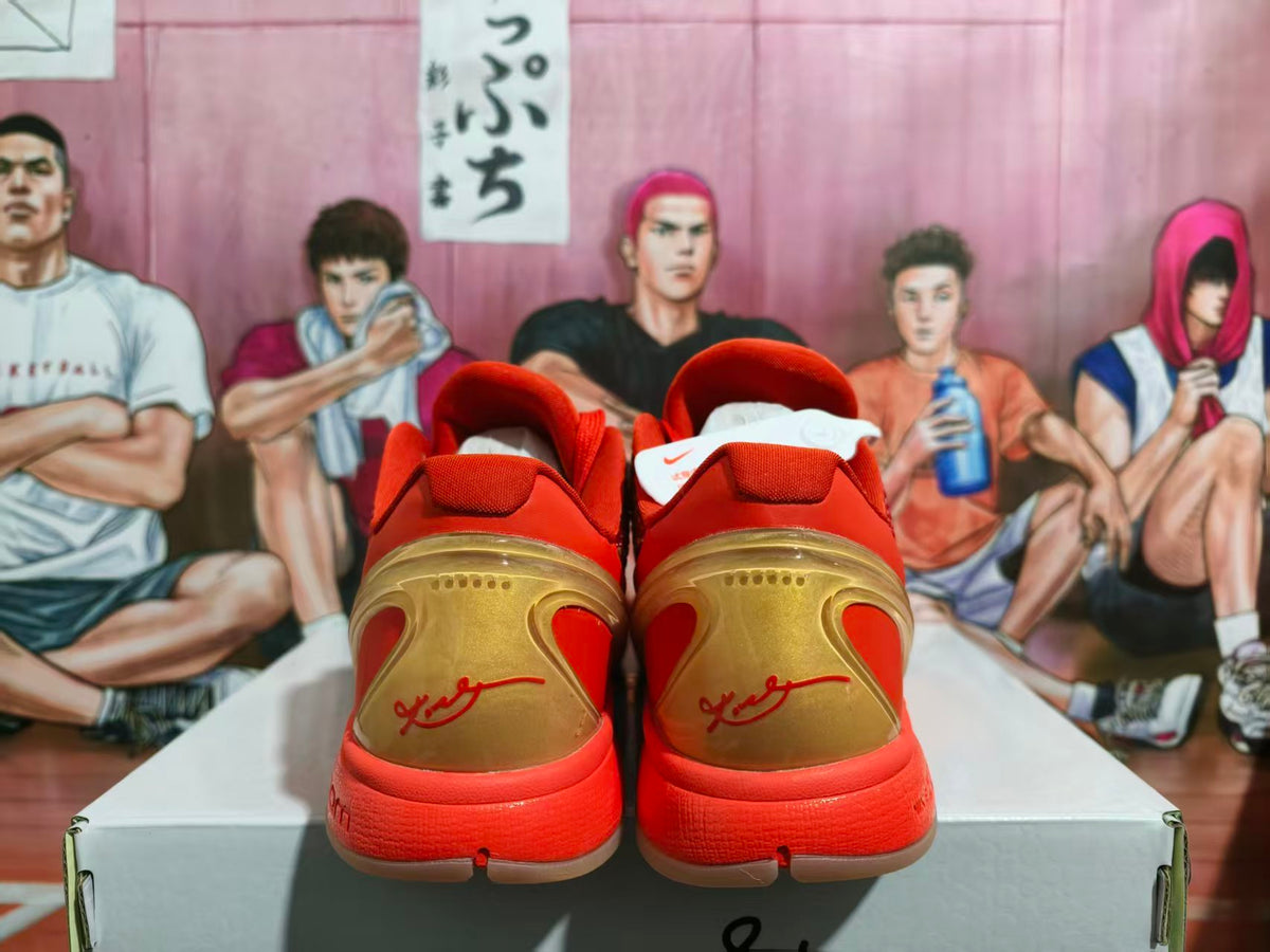 Rear view of red and gold Nike basketball sneakers displayed on a shoebox.