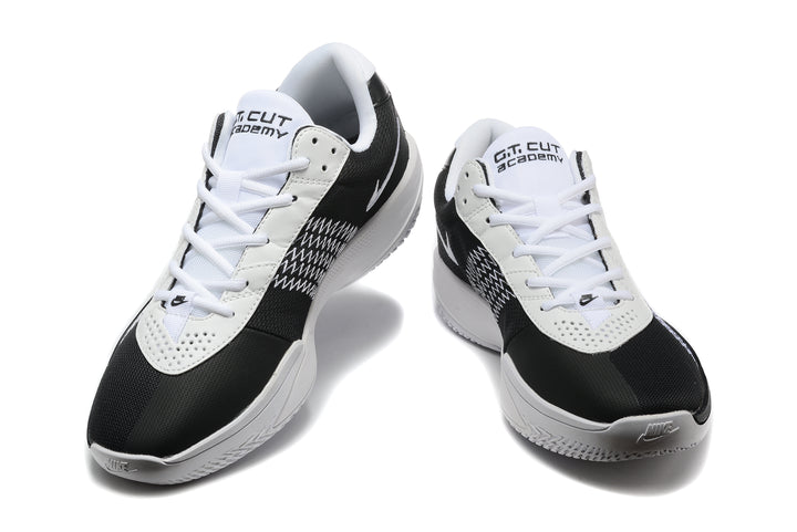 Pair of black and white Nike G.T. Cut Academy basketball shoes shown from the front.