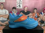 Side view of a blue sneaker showing the orange dragon-decorated side panel and “FLOW” midsole marking.